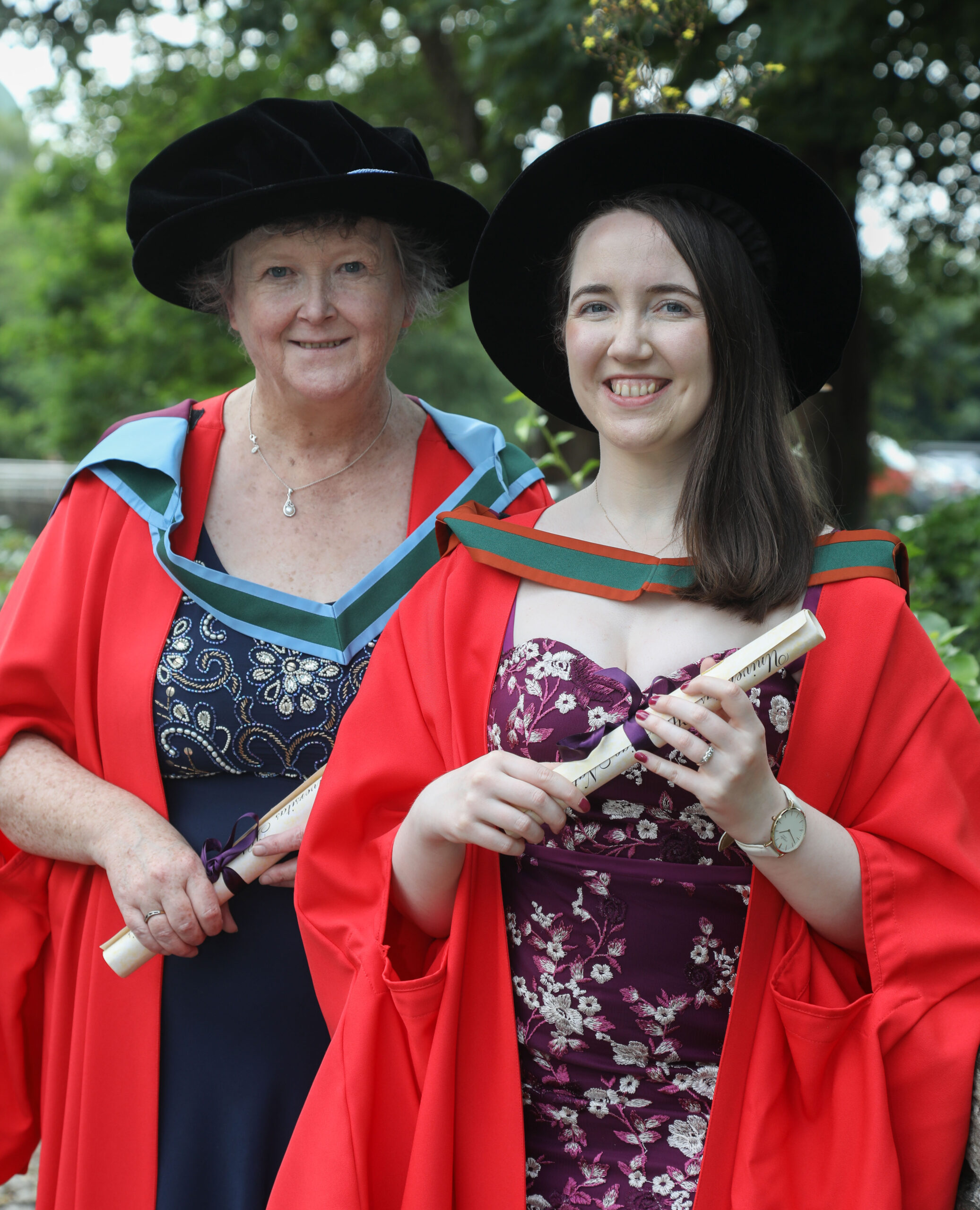 Two researchers pictured at their graduation