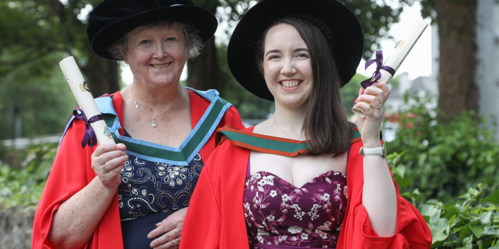 Two researchers pictured at their graduation