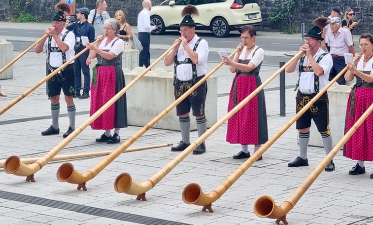 People in traditional dress blowing horns