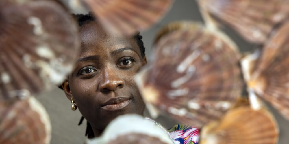 Woman pictured surrounded by scallop shells