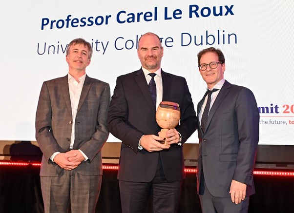 IRC Director Peter Brown and IRC Chair Daniel Carey presenting a trophy to Professor Carel le Roux