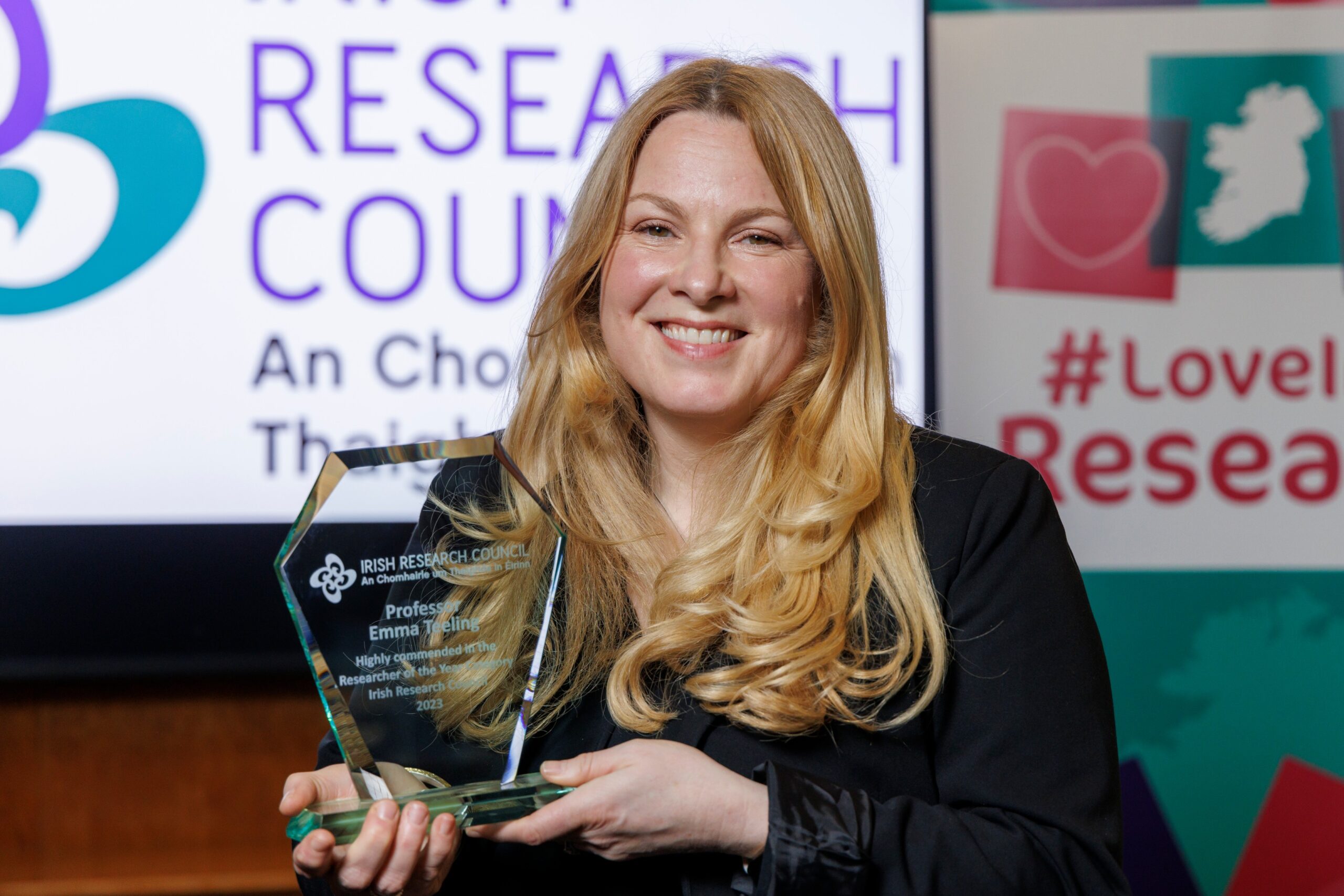 Professor Emma Teeling pictured holding a trophy